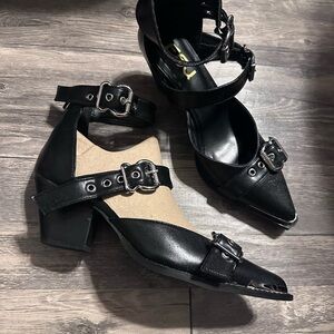Black heels with adjustable ankle straps with zipper in back.  New without tags